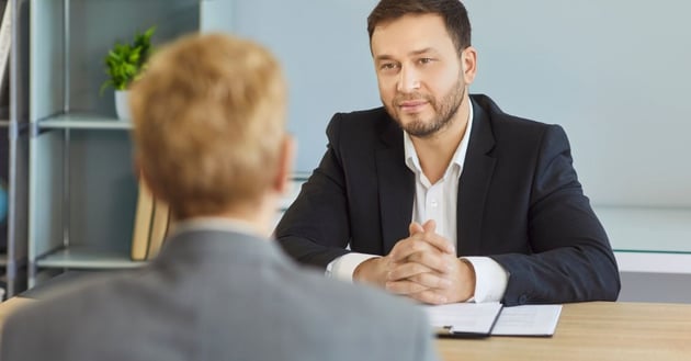 HR manager conducting a formal employee disciplinary meeting in a professional office setting